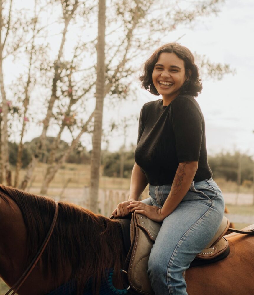 happy woman on horse Happy woman sitting on a horse