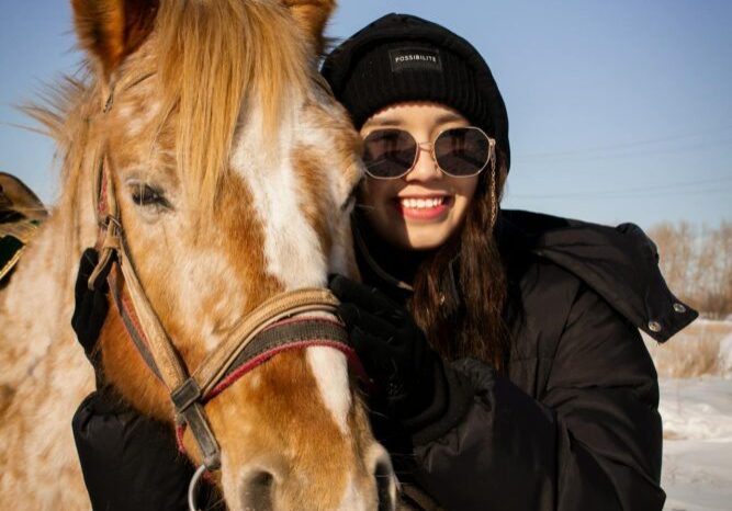 woman smiling with horse